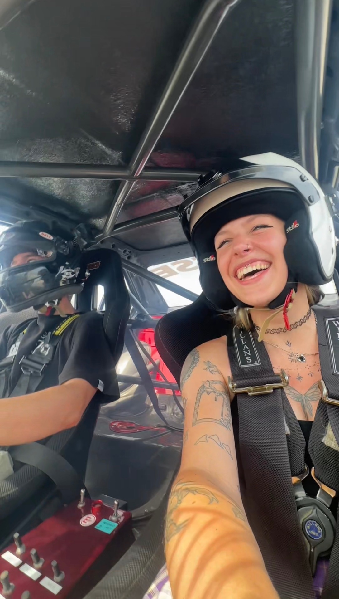 In the passenger seat of a race car
